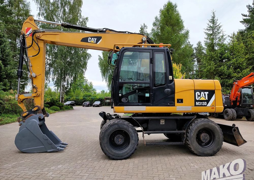 Caterpillar M313D - Колесен багер: снимка 1 Caterpillar M313D - Колесен багер: снимка 1