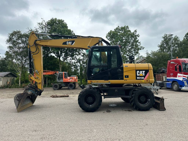 Cat M 313 D - Колесен багер: снимка 1 Cat M 313 D - Колесен багер: снимка 1