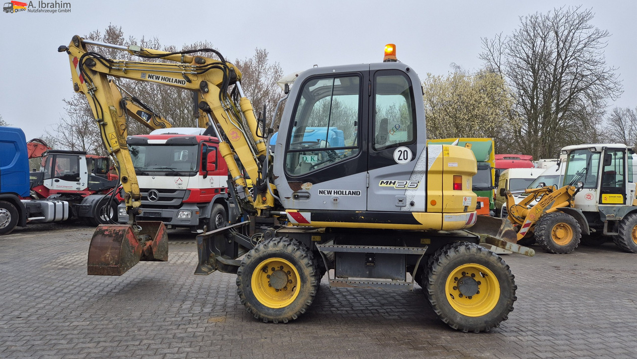New Holland MH 2.6 Zustand gut, deutsche Maschine incl. Greifer und Dreservo - Колесен багер: снимка 1 New Holland MH 2.6 Zustand gut, deutsche Maschine incl. Greifer und Dreservo - Колесен багер: снимка 1