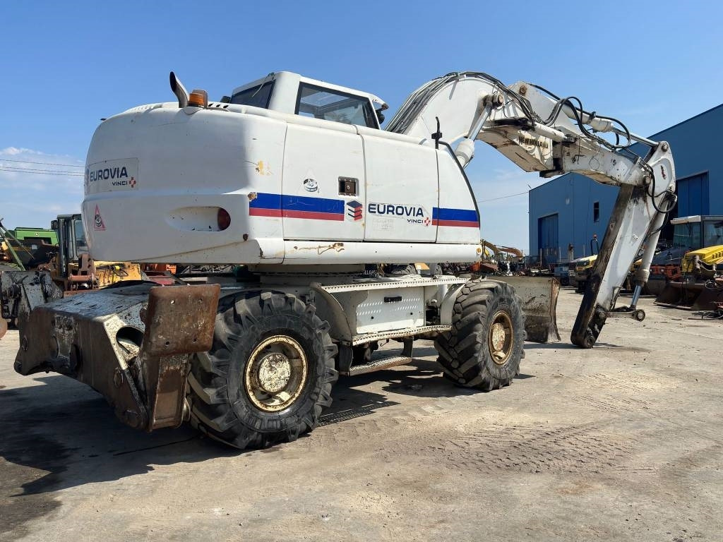 New Holland MH Plus - Колесен багер: снимка 4 New Holland MH Plus - Колесен багер: снимка 4