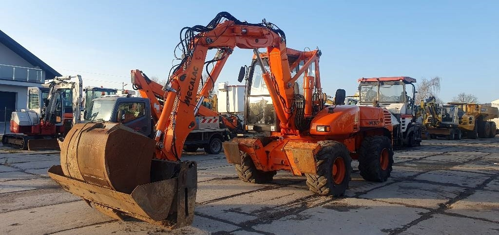 Mecalac 12 M TX - Колесен багер: снимка 1 Mecalac 12 M TX - Колесен багер: снимка 1