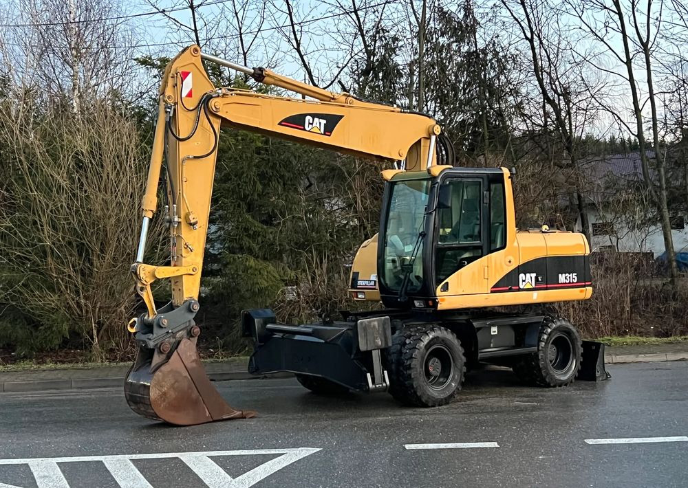 Caterpillar CAT M315C CATERPILLAR SPROWADZONY Bardzo Dobry Stan - Колесен багер: снимка 1 Caterpillar CAT M315C CATERPILLAR SPROWADZONY Bardzo Dobry Stan - Колесен багер: снимка 1