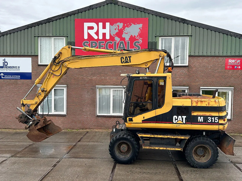 Caterpillar M315 +ROTO CE - Колесен багер: снимка 1 Caterpillar M315 +ROTO CE - Колесен багер: снимка 1